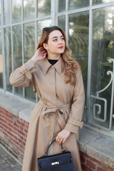 a lady in a brown long coat